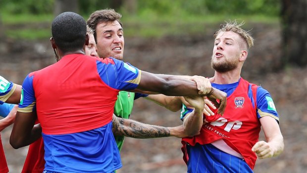 Getting physical: Sam Gallagher and Edson Monsanto clash at Jets training on Monday.