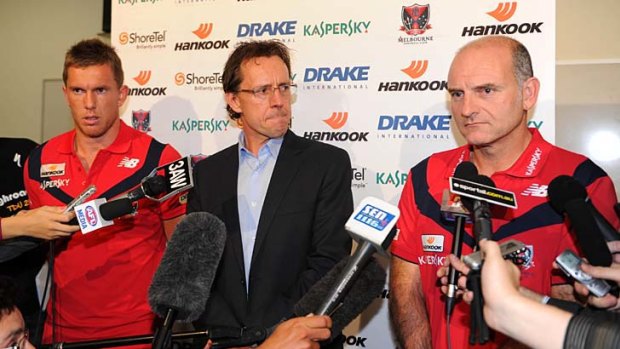 Pressure builds: Club chief executive Cameron Schwab, centre stage, with coach Dean Bailey and Brent Moloney (far left).