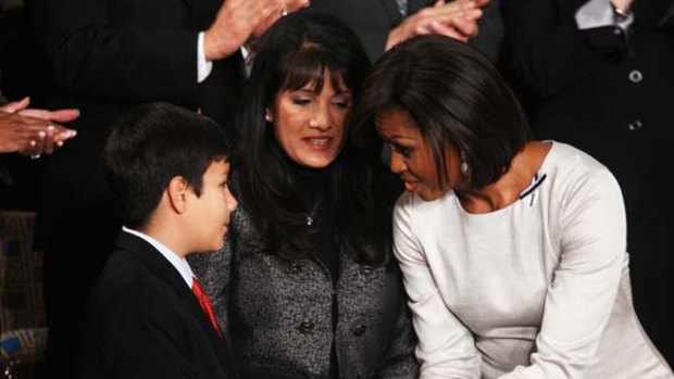 Share the pain ... Michelle Obama greets the family of Christina-Taylor  Green, 9, who was fatally wounded in Tucson.