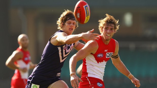 Race is on: Swan Alex Johnson has his sights set on the ball as  Docker Nahan Fyfe closes in to make a contest.
