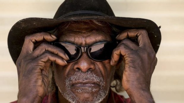 Jeffrey John of the Molgin community, wearing the sunglasses protect his eyes given to him by the Fred Hollows Foundation, arrives to have his eyes examined.