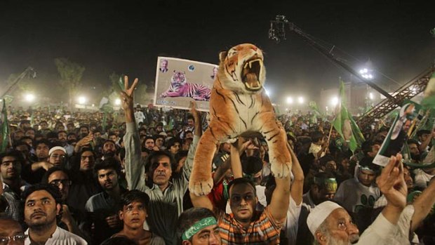 Down to the wire: Supporters listen to Pakistan Muslim League-Nawaz leader Nawaz Sharif during a rally in Lahore.