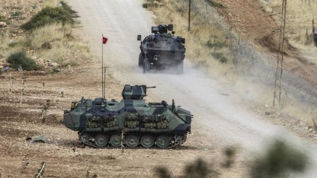 Turkish tanks man a position facing the Islamic State fighters 10 kilometres west of Kobane.
