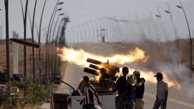 Anti-Gaddafi forces fire rockets near the city of Sirt, one of the few remaining strongholds for besieged loyalists.