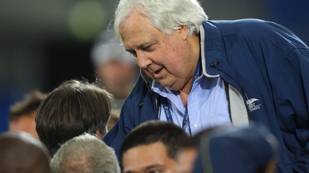 Clive Palmer speaks to Gold Coast players before a match last year.