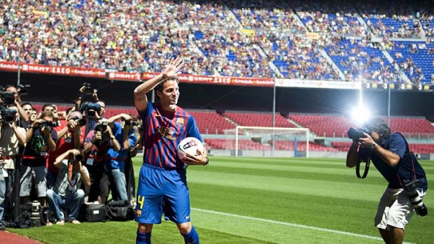 The homecoming: Cesc Fabregas is welcomed back to the Nou Camp on Tuesday.