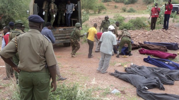 Kenyan soldiers and Red Cross workers remove the bodies of 36 non-Muslim workers at a quarry in  northeast Kenya.