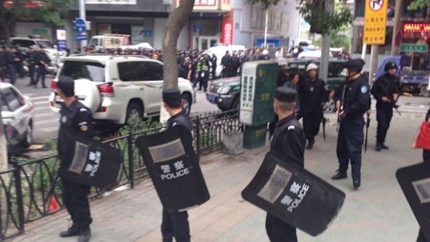 Police officers stand guard near the blast site in a market in Urumqi.