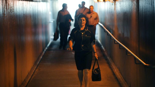 Public Transport Minister Lynne Kosky walks through an underpass to catch a train after the bridge opening ceremony.