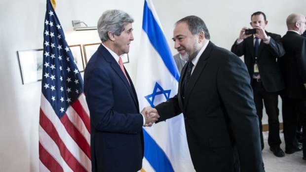 Israeli Foreign Minister Avigdor Lieberman (right) greets US Secretary of State John Kerry (left) ahead of their meeting in Jerusalem. 