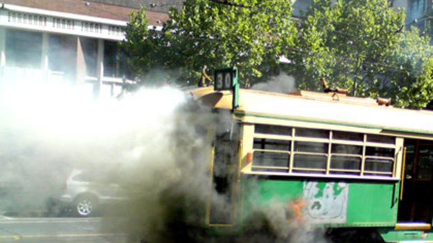 Smoke billows from a W-class tram after it caught fire in La Trobe Street.