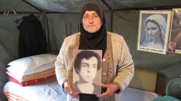 Majida Bashasha, with a photo of her missing brother Ahmad, in the tent she lives in outside the United Nations offices in Beirut.