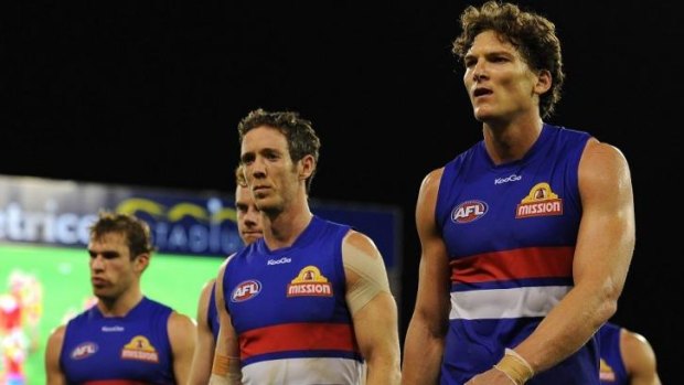 Dog tired: Will Minson (right)  looks dejected as he leaves the field after the match against the Suns.