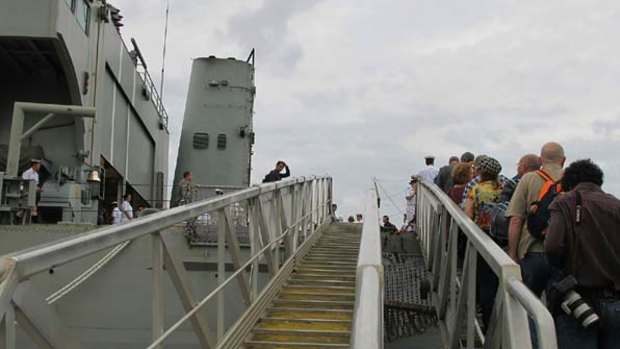 Relatives and friends of Centaur victims board the HMAS Manoora for today's memorial.