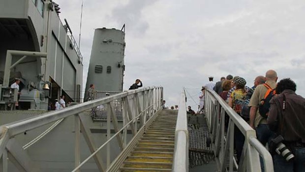 Relatives and friends of Centaur victims board the HMAS Manoora for today's memorial.