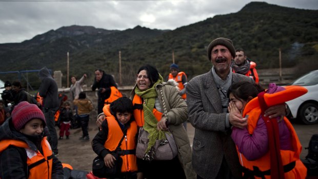 Thursday, December 3: Yazidi refugee Samir Qasu, his wife Bessi children Dunia and Dildar are overcome with emotion after landing on the Greek island of Lesbos.  