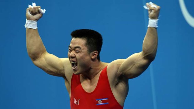 Kim Un Guk celebrates after his record lift.