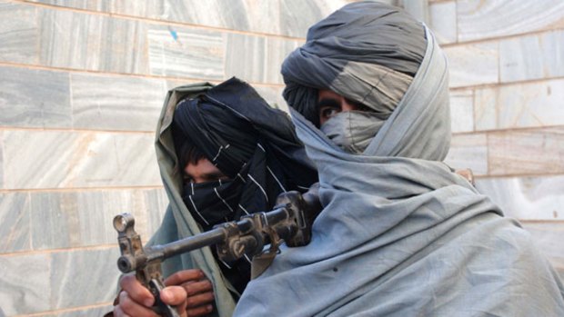 Two Taliban militants who have surrendered stand with their weapons in Afghanistan's Herat province at the weekend.