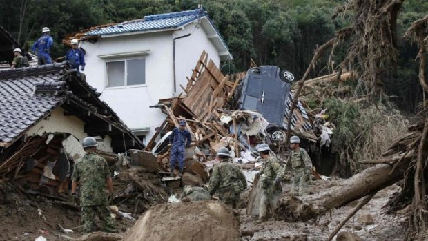 Japanese soldiers search for survivors after the landslide.