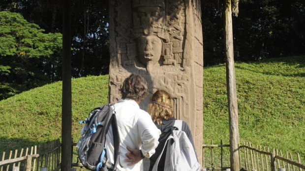 Tourists look at a Mayan stela at the Quirigua archaeological site. Ceremonies will be held here to celebrate the end of the Mayan cycle known as Bak'tun 13 and the start of the new Maya Era on December 21.
