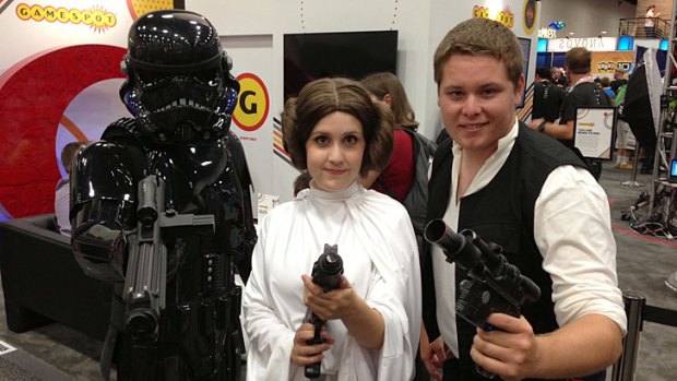 Young fans dress, from left, as Shadow stormtrooper, Princess Leia and Han Solo from <i>Star Wars</i>, at Comic-Con.