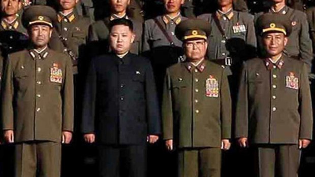 Kim Jong Un, in black,  poses with Chief of the General Staff,  Ri Yong Ho, far right, in October 2010.