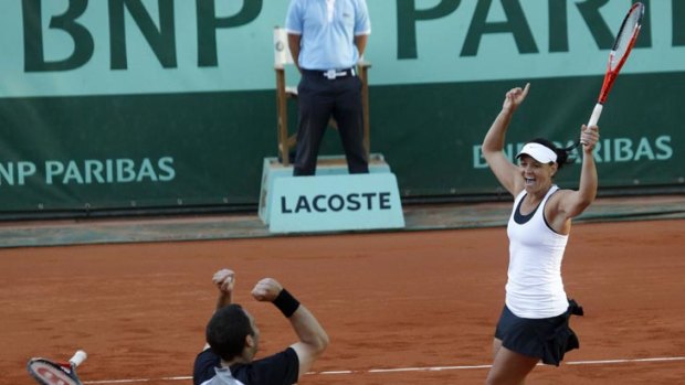 Australia's Casey Dellacqua (right) celebrates with her partner Scott Lipsky, of the USA, after the pair defeated Slovenia's Katarina Srebotnik and Serbia's Nenad Zimonjic in the French Open mixed doubles final at Roland Garros.