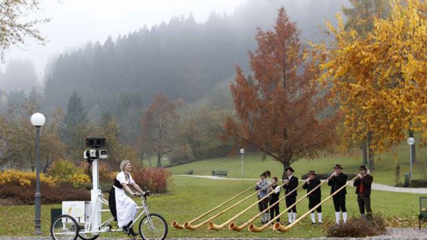 Street View cameras on a trike ... a tourist marketing chief  passes a group of musicians playing alphorns as she rides  in Oberstaufen
