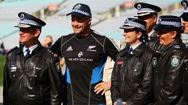 All Blacks captain Richie McCaw poses with members of the NSW police force at ANZ Stadium yesterday.