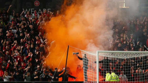 A flare is lit amongst Wanderers fans during the round 27 A-League match between the Western Sydney Wanderers and Perth Glory at Pirtek Stadium.