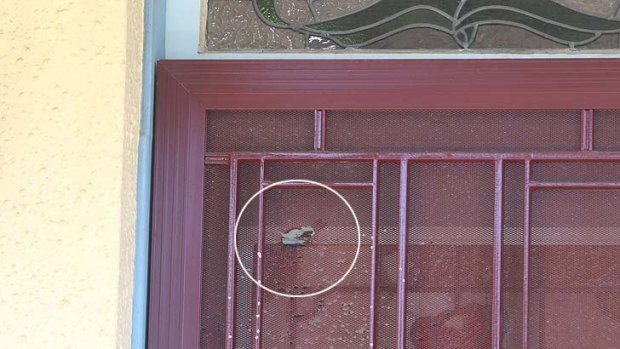 The bullet hole in the front door of the house owned by  Tony Golossian.