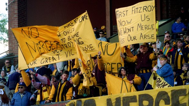 Hawthorn supporters attend an anti-merge rally at Glenferrie Oval.