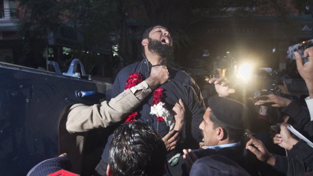 Malik Mumtaz Hussain Qadri, the bodyguard arrested for the killing of Punjab Governor Salman Taseer, shouts religious slogans while being taken away by police after he was presented at a court in Islamabad.