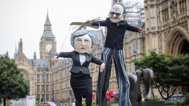 Campaigners from Avaaz dressed as British Prime Minister Theresa May and Australian media mogul Rupert Murdoch.