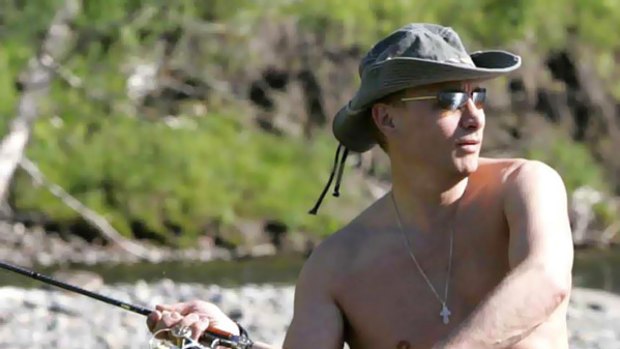 Fly boy: A poster of the topless Vladimir Putin fishing is included in the issue of the gossip magazine dedicated to the Russian leader. PICTURE: REUTERS