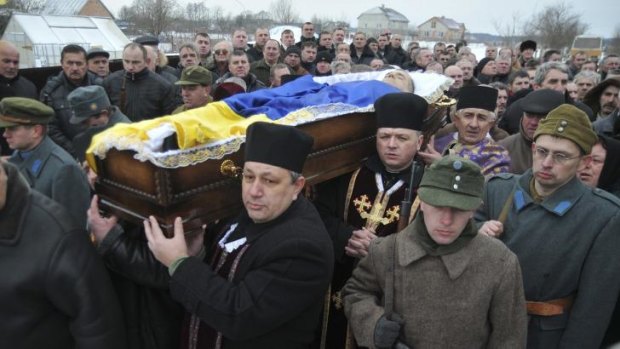 Ukrainian priests and protesters carry the coffin of Roman Senyk  in Nakonechne Druhe, western Ukraine, on January 27. Senyk died of gunshot wounds inflicted during protests in the Ukrainian capital, Kiev, on January 22.