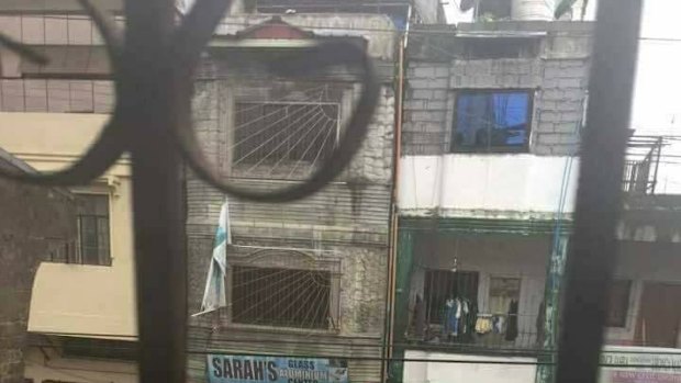 A vehicle flies the Islamic State flag on the streets of Marawi City on Tuesday.