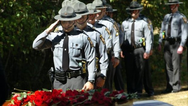 Pennsylvania State Troopers stand in line to salute the casket of Pennsylvania State Trooper Corporal Bryon  Dickson during his funeral service on Thursday.