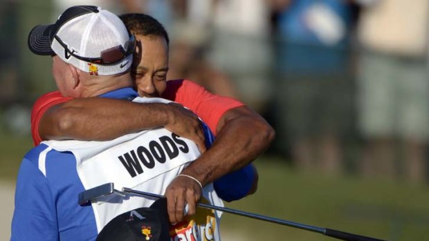 New Tiger ... Woods embraces caddy Joe laCava after winning the Arnold Palmer Invitational in Orlando, Florida.