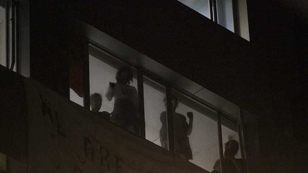 Occupying ...  protesters wait for police to evict them from an empty Clarence Street office building last night.