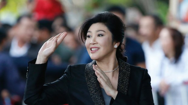 Former Thai prime minister Yingluck Shinawatra waves to supporters as she arrives at the Supreme Court for her final statements on August 1.