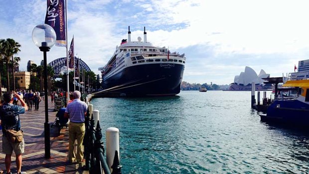 Onlookers photograph the Queen Mary 2 at Circular Quay in Sydney on Wednesday morning.