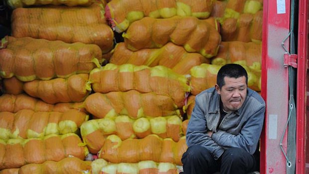A slow day for a Chinese vegetable vendor.