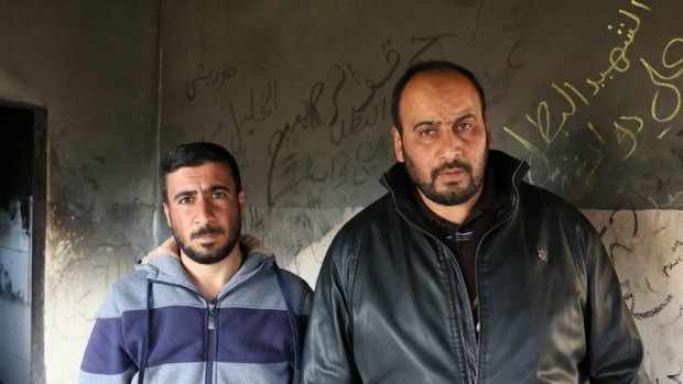 Hassan Dawabshe, left, the brother of Riham Dawabshe, and Nasser Dawabshe, the brother of her husband Saad, in the house where the couple and their son were fatally wounded in an arson attack.