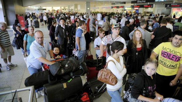Long queues formed at a Qantas check-in at Melbourne Airport yesterday after a breakdown of the check-in system.