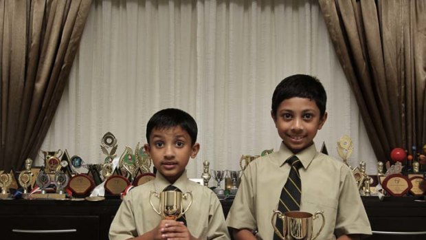 Told to find another school ... Kevin and Rowan Willathgamuwa at home with many of their trophies. Their parents were advised not to take them to Brazil.