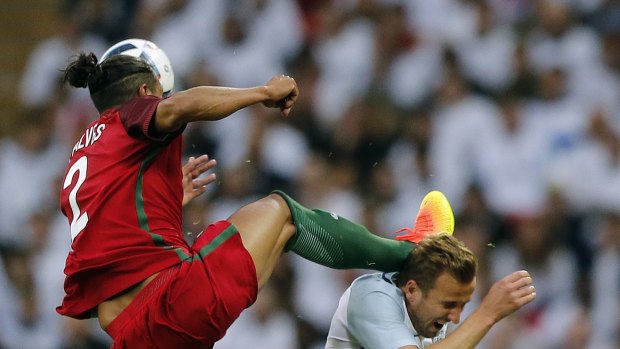 Red mist: Bruno Alves challenges Harry Kane at head height.