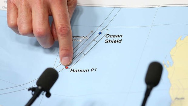 Angus Houston holds a map outlining the current search areas.