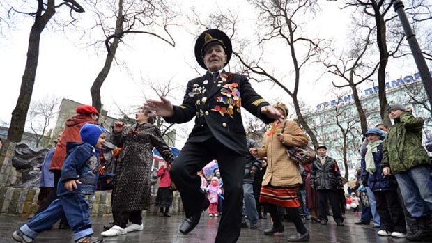 Far east ... a war veteran dances on Victory Day this year.