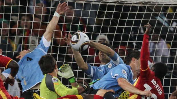 Red card ... Uruguay's goalkeeper Fernando Muslera (centre) watches striker Luis Suarez blocking the ball with his hands to deny Ghana in the 2010 World Cup quarter final. 